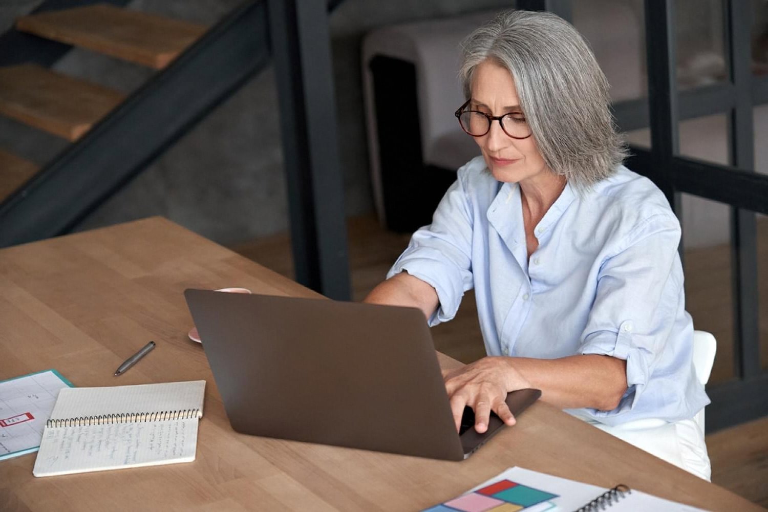 HR professional reviewing an emotional intelligence assessment report on a laptop